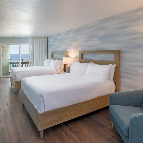 A bright, modern hotel room with a large bed, desk, seating area, and stylish decor, plus a window view and soft lighting. End sentence.